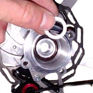 Inserting a shim washer to adjust the axial clearance